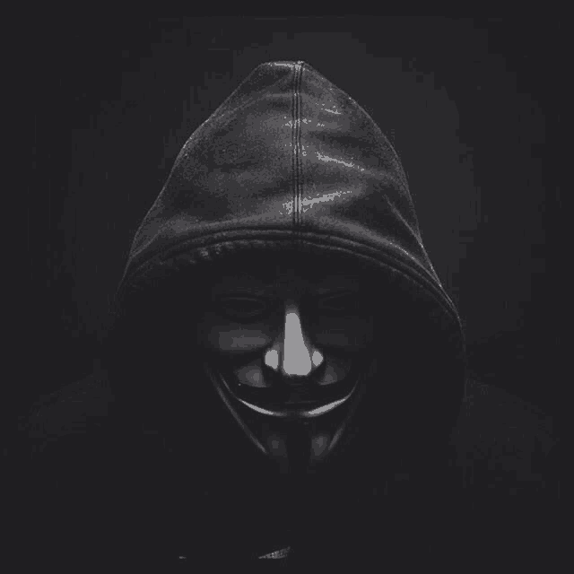 a man wearing a hooded jacket and a mask