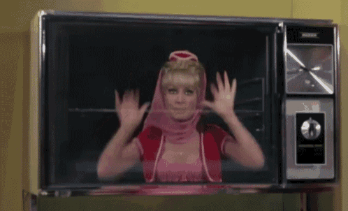 a woman in a pink dress is appearing on a tv screen