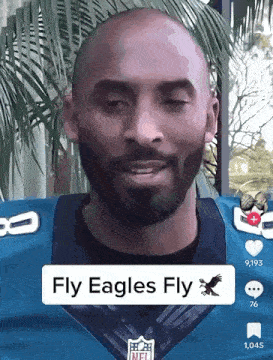 a bald man with a beard is wearing a nfl jersey