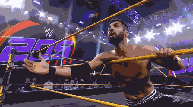 a man in a wrestling ring with a w logo on the back