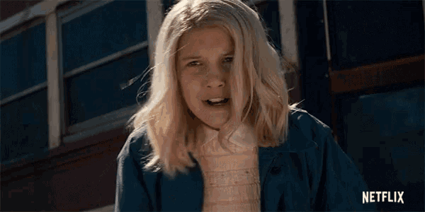 a girl with blonde hair is standing in front of a netflix ad