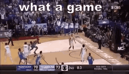 a basketball game is being played in front of a crowd and the words what a game are on the screen .