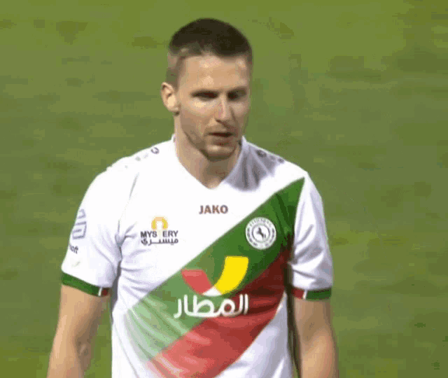 a soccer player wears a jersey that says jako on the front