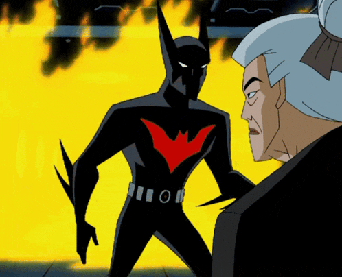 a man in a suit stands next to a batman with a red wing