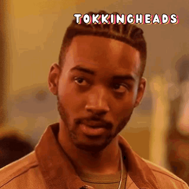 a close up of a man 's face with the word tokingheads above him
