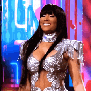 a woman in a silver outfit is smiling in front of a sign that says l.