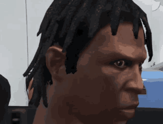 a close up of a man 's head with dreadlocks