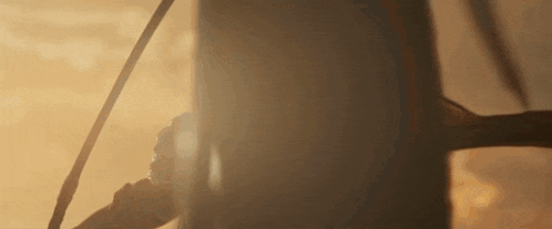 a close up of a person holding a sword in the dark .