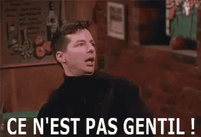 a man is standing in a bar with his eyes closed and a sign that says `` ce n'est pas gentil '' .
