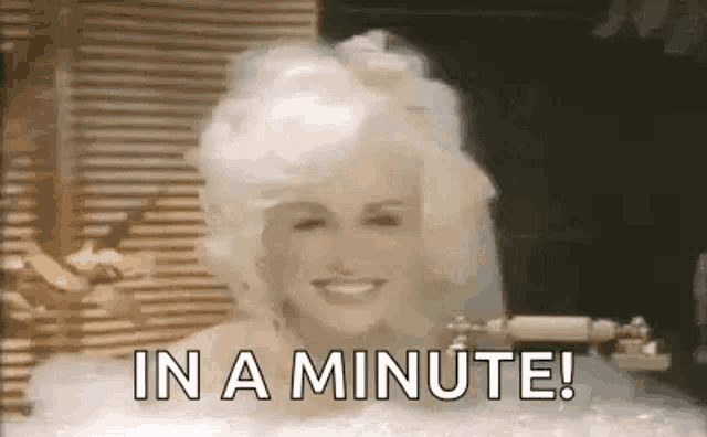 dolly parton is smiling in a bathtub with the words `` in a minute ! ''