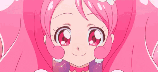 a close up of a pink haired anime girl with a crown on her head .