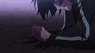a man in a black jacket is laying on the ground with blood on his arm .