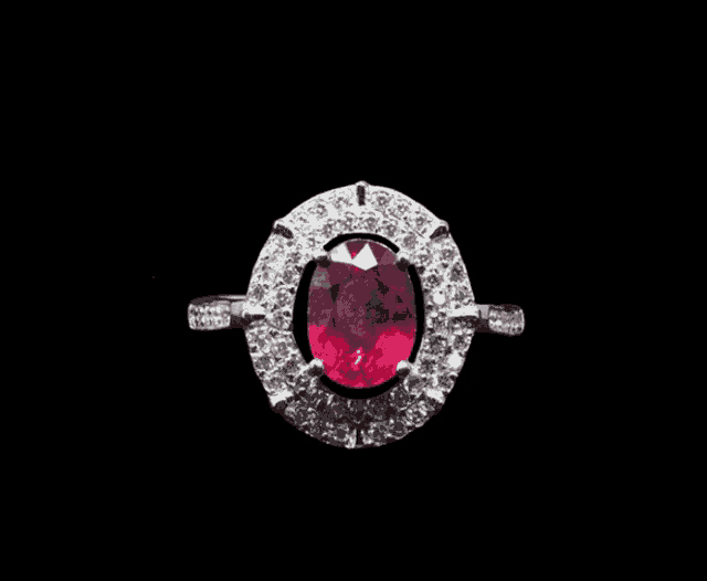 a ring with a red stone and white diamonds