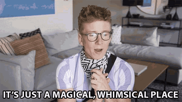 a man wearing glasses and a scarf is saying it 's just a magical whimsical place
