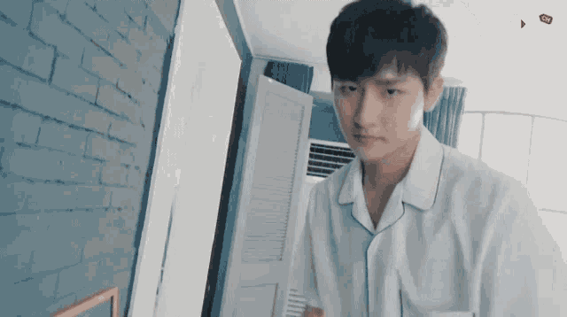 a man in a white shirt is standing in a room with the word mx on the bottom left