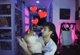 a man is holding a dog in front of a sign that says mallowissa