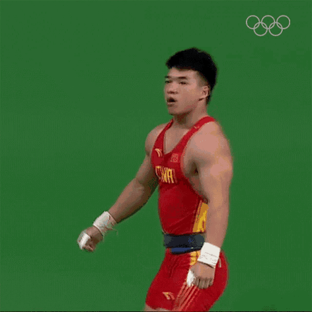 a wrestler from china is standing on a green background
