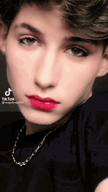 a close up of a man 's face with red lipstick and a tiktok watermark