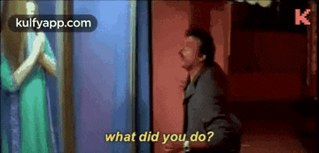 a man is standing in front of a mirror talking to a woman and asking what did you do .