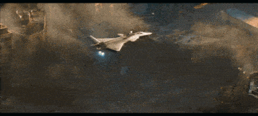 a fighter jet is flying over a city