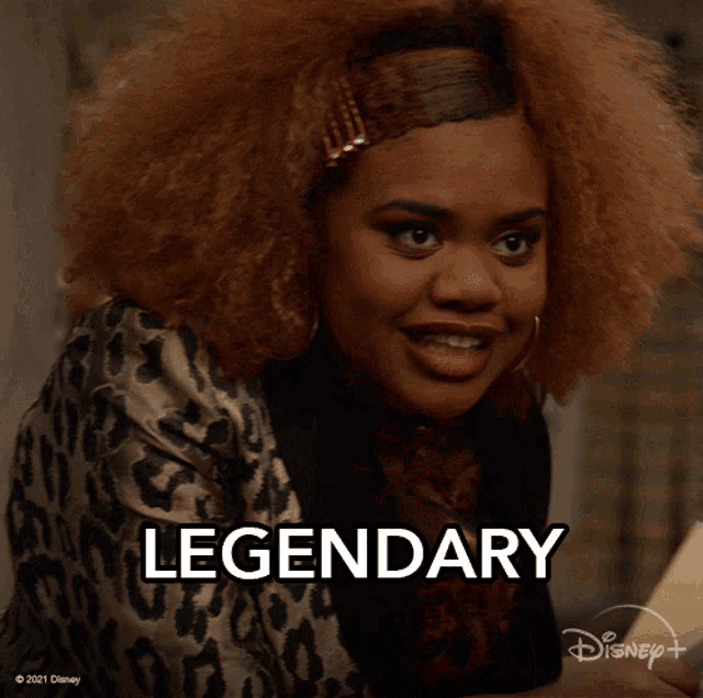a woman with a leopard print shirt and the word legendary behind her