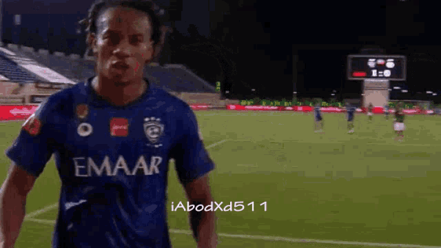a soccer player wearing a blue emaar jersey