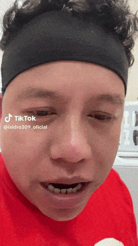 a man wearing a headband and a red shirt has a tiktok watermark on his face