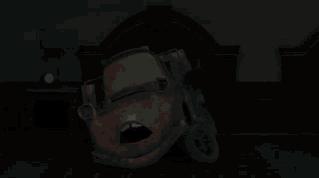 a tow truck from the movie cars is smiling in the dark