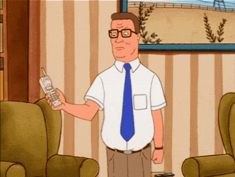 a man in a white shirt and blue tie is holding a cellphone
