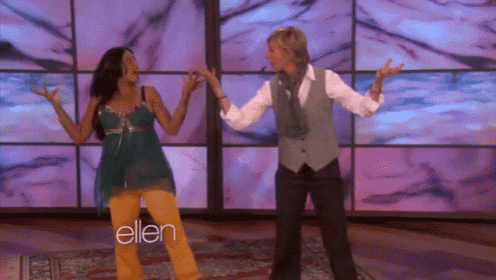 two women are dancing in front of a screen that says ellen on it