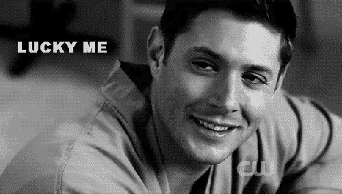 a black and white photo of a smiling man with the words lucky me above him .