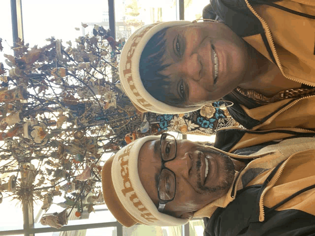 a man and a woman wearing a headband that says timberland