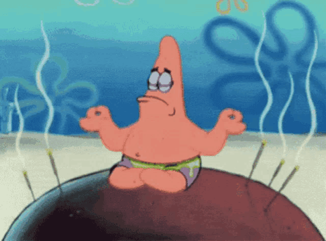 patrick star from spongebob sits on a rock with his eyes closed