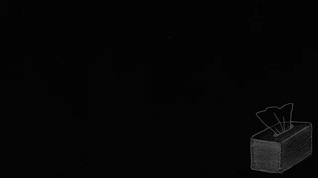 a box of tissues is sitting on a black surface .