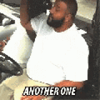 a man with a beard is sitting in the back seat of a car and says another one .