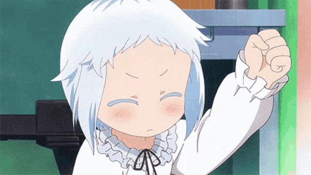 a little girl with white hair is making a fist in the air