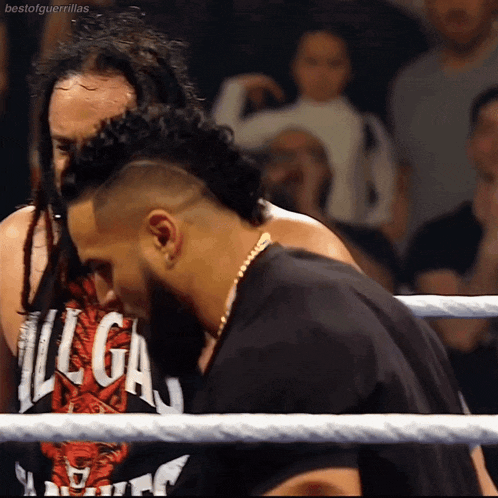 two men in a wrestling ring with one wearing a shirt that says ' liga ' on it