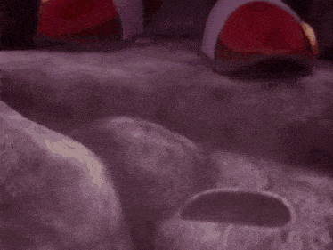 a close up of a sonic the hedgehog standing in a rocky area