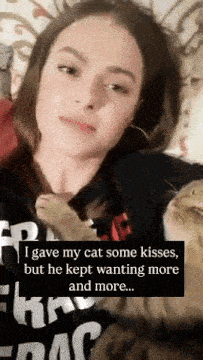 a woman is laying on a bed with two cats and says i gave my cat some kisses