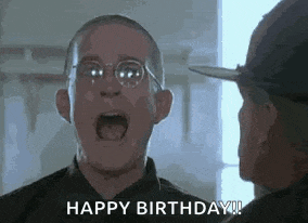 a man with glasses is screaming and saying `` happy birthday ! ''
