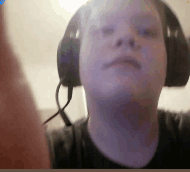 a man wearing headphones is taking a selfie