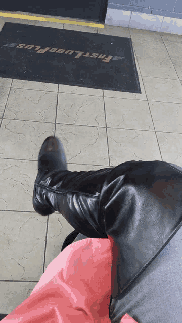 a person sitting in front of a fast lube plus door