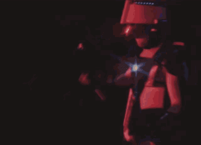 a person playing a keyboard with a red light shining on it