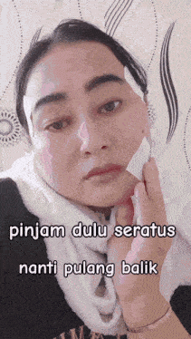 a woman with a bandage on her face and the words pinjam dulu seratus