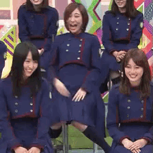 a group of girls in blue uniforms are posing for a picture together