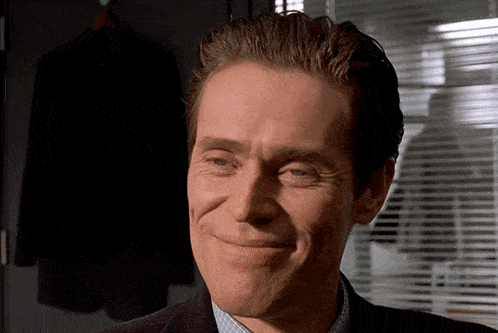 a close up of a man 's face with a smile