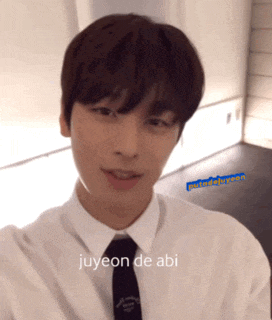a young man wearing a white shirt and tie with the words juyeon de abi on the bottom