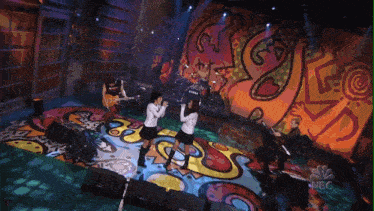 a group of people on stage with a tama drum set in the background