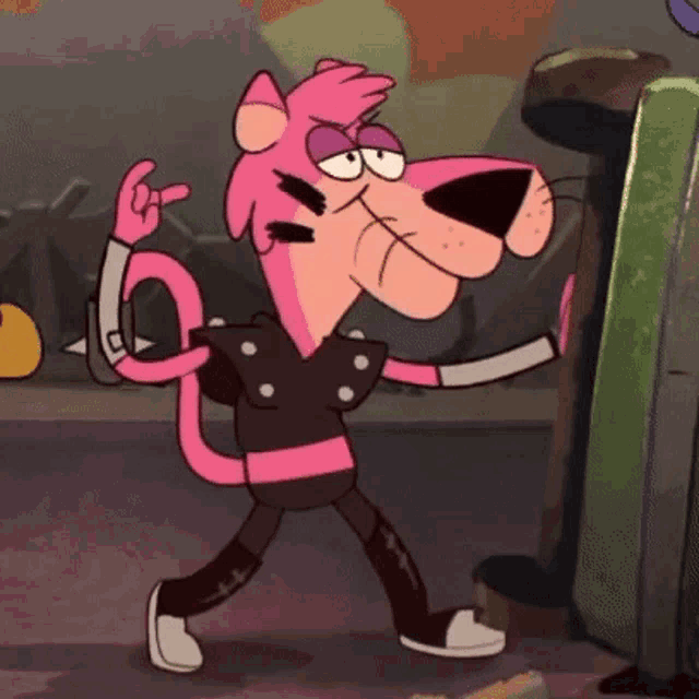 a pink panther is wearing a black shirt and black pants and making a rock sign .