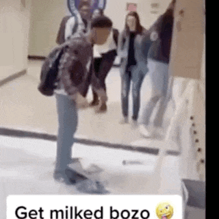 a man with a backpack is standing on the floor in a hallway .